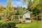 Farm house chicken coop wiwth covered outdoor area.