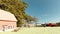 Farm with a house in an open prairie field at noon, horses, bulls and truck. Concept of wild daily life and work and