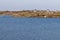 Farm houses, Vegetation and rocks around Clifden bay