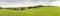 Farm land in the middle of green field. Panoramic rural autumn scenery in North Rhine Westphalia in Germany