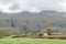 Farm landscape with a vehicle visible on the Swartberg Pass