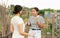 Farm owner scolding female worker during harvest.