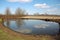 farm pond, with visible black runoff from nearby fields