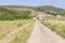 Farm road in Carrapateira with mountain, houses and vegetation