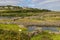 Farm with rock walls, lake and fields in Inisheer Island