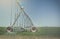 Farm\'s crop being watered by sprinkler irrigation system