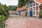 Farm with several houses with blue old wooden doors , surrounded by green beautiful plants