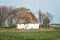 Farm with thatched roof in the North Holland flower fields in th