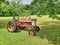 Farm tractor in front of a recently-mowed field