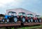 Farm tractors loaded on a freight train. Import/export of the agriculture and farming equipment.