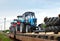 Farm tractors loaded on a freight train. Import/export of the agriculture and farming equipment.