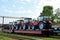 Farm tractors loaded on a freight train. Import/export of the agriculture and farming equipment.