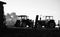 Farm Tractors Parked by Hay Bales