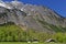 Farm in valley at a mountain massif