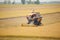 Farm worker harvesting rice with Combine machine