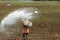 A farm worker throws the fertilizer in the paddy fields of Kuttanad