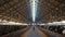 Farm worker walking cowshed alone. Livestock supervisor inspect dairy facility.