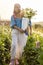 Farm workers pick up dahlia flowers at rural farm outdoors