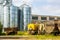 Farm yard with agricultural trailers, tanks and grain storage