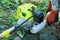 Farmer adding petrol gas to the gasoline tank of the trimmer brushcutter in the field