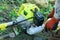 Farmer adding petrol gas to the gasoline tank of the trimmer brushcutter in the field