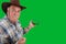 A farmer advertises something holding a smartphone with a green screen.