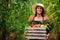 Farmer, agriculture and portrait of woman with box on farm after harvest of summer vegetables. Farming, female person