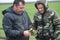 Farmer with agronomist analyze the development of wheat seedlings on the field in the spring