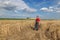 Farmer or agronomist inspect damaged wheat field