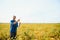 A farmer agronomist inspects soybeans growing in a field. Agriculture