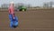 Farmer, agronomist stands on farm field, tests, using tablet, quality of Agriculturally potatoe cultivation, planting