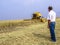 Farmer analyzing worl of combine harvester