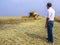 Farmer analyzing worl of combine harvester