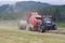 Farmer baling hay in a misty mountain pasture