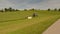 A farmer in Bavaria cuts the grass in a field in summer. Farmer with agricultural equipment mows the meadow and makes