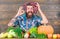 Farmer bearded guy with homegrown harvest grapes put on head. Farmer proud of grapes harvest. Fresh organic harvest