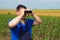 Farmer with binoculars in corn field