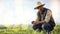 Farmer, black man and mockup for agriculture and sustainability outdoor on an agro farm with bokeh. Person on grass
