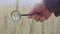 Farmer` or botanist`s hand with magnify glass tool closeup check examine inspect wheat spikelets of rye in agricultural