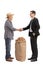 Farmer with a burlap sack shaking hand with a businessman