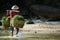 Farmer carrying sea weed in  bamboo basket