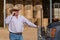 Farmer on cell phone smiling, near truck with antennas