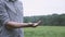 Farmer in checkered shirt pouring dry peas from hand to hand . Clenches his fist .