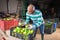 Farmer checking picked green tomatoes at farm warehouse