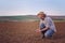 Farmer Checking Soil Quality of Fertile Agricultural Farm Land