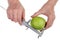 Farmer checks the size and quality of ripe green apple fruit  using a steel caliper  isolated macro