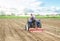 The farmer cleans and turns the soil in the farm field for further sowing with agricultural crops. Loosening surface