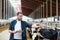 Farmer with clipboard and cows in cowshed on farm