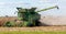 A farmer combining a field of corn