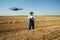 Farmer Control a drone on the wheat field.